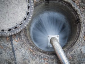pressurized water cleaning a sewer pipe